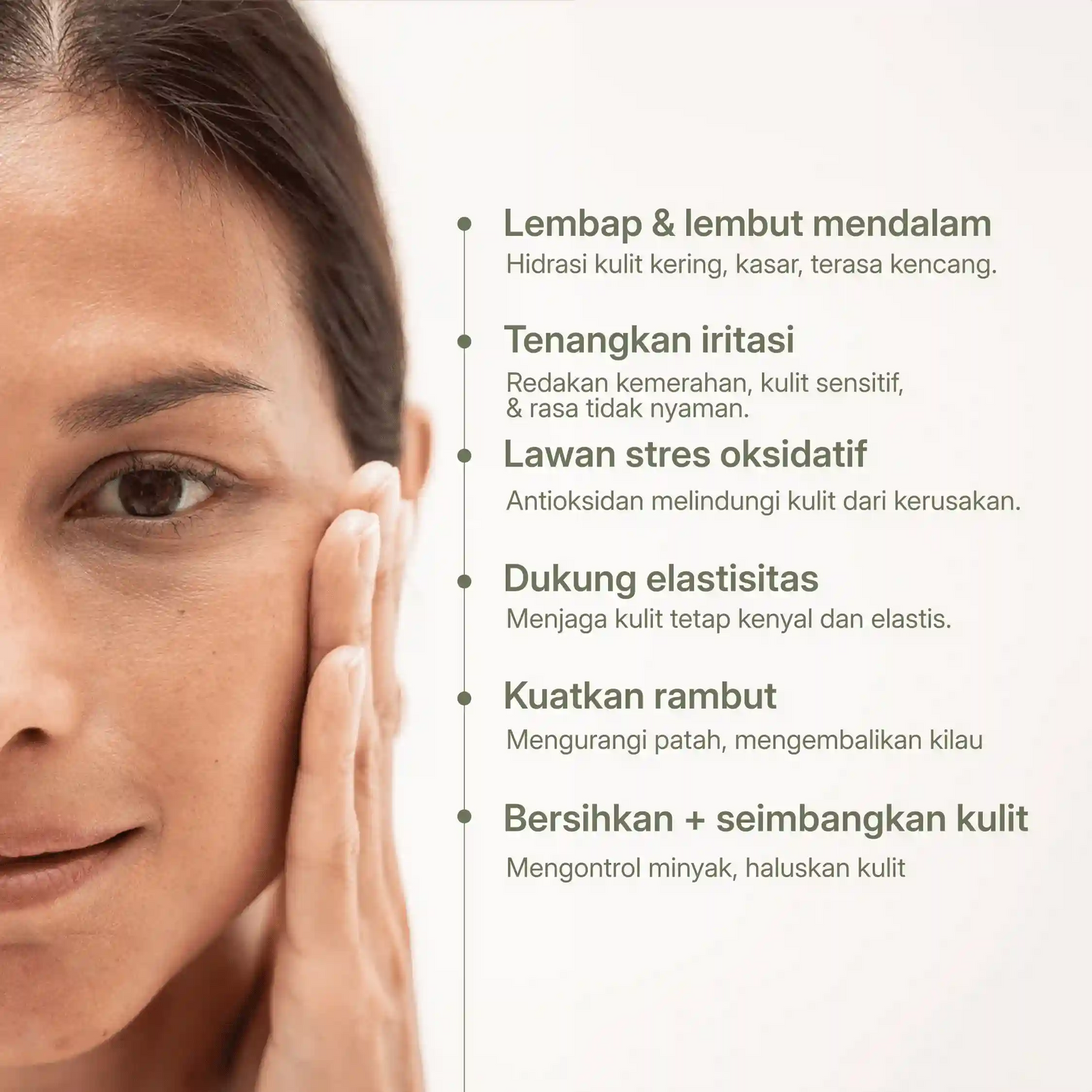 Seorang wanita menyentuh wajahnya dengan daftar manfaat minyak moringa untuk kulit dan rambut, termasuk melembapkan, menenangkan, meningkatkan elastisitas, dan kilau.