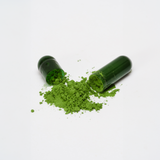 Open Organic Moringa Capsule by Treelogy spilling vibrant green powder — made from stem-free, dehydrated moringa leaves farmed and crafted in Bali.