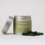 Treelogy Organic Moringa Capsules with tin open and capsules displayed — made from stem-free, low-temperature dehydrated moringa leaves.