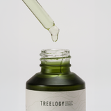 Treelogy Organic Moringa Oil with dropper dispensing a clear drop — cold-pressed from pure moringa seeds and handcrafted in Bali.