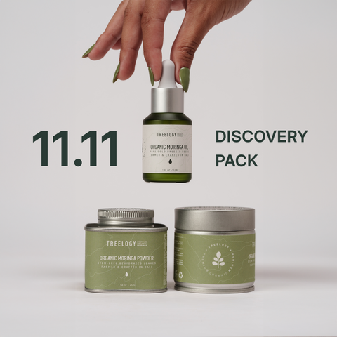 Treelogy 11.11 Discovery Pack featuring three premium organic moringa products — cold-pressed moringa seed oil (30 ml), stem-free moringa powder (45 g), and moringa capsules (90 pcs) — regeneratively grown and hand-crafted in Bali. Minimalist white background with a hand holding the oil bottle.