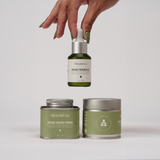 Hand showcasing Treelogy Organic Moringa Oil above capsules and powder tins — a complete ritual for health from inside out and outside in.