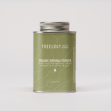 Front view of Treelogy Organic Moringa Powder tin — stem-free leaves gently dehydrated at 38°C for optimal nutritional integrity.